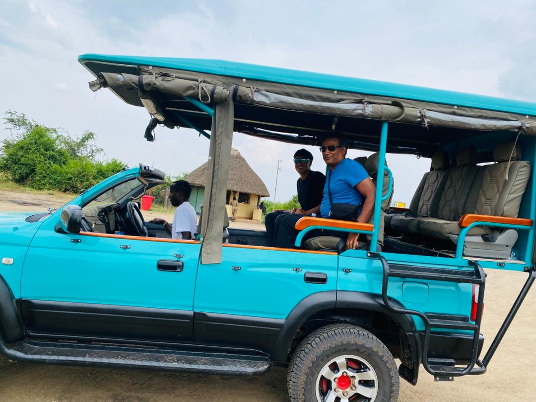 Safari vehicle with tourists on a Uganda wildlife adventure